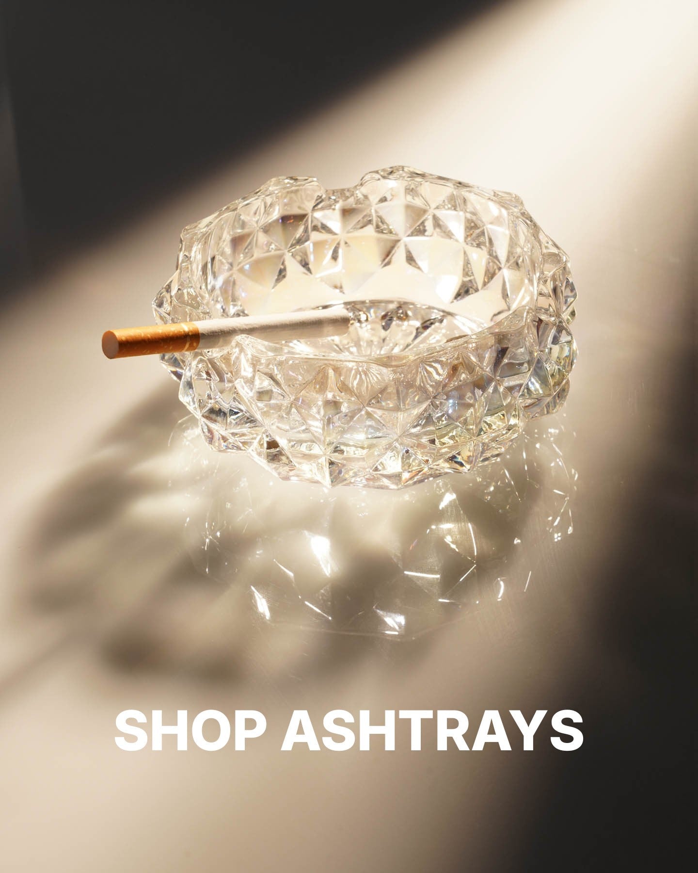 iridescent ash tray with cigarette sitting inside. 