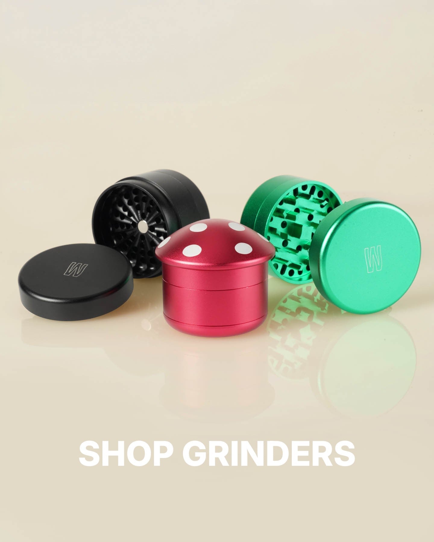 collection of 3 metal herb grinders. Showing a toothless grinder, a mushroom grinder, and a magnetic grinder. 