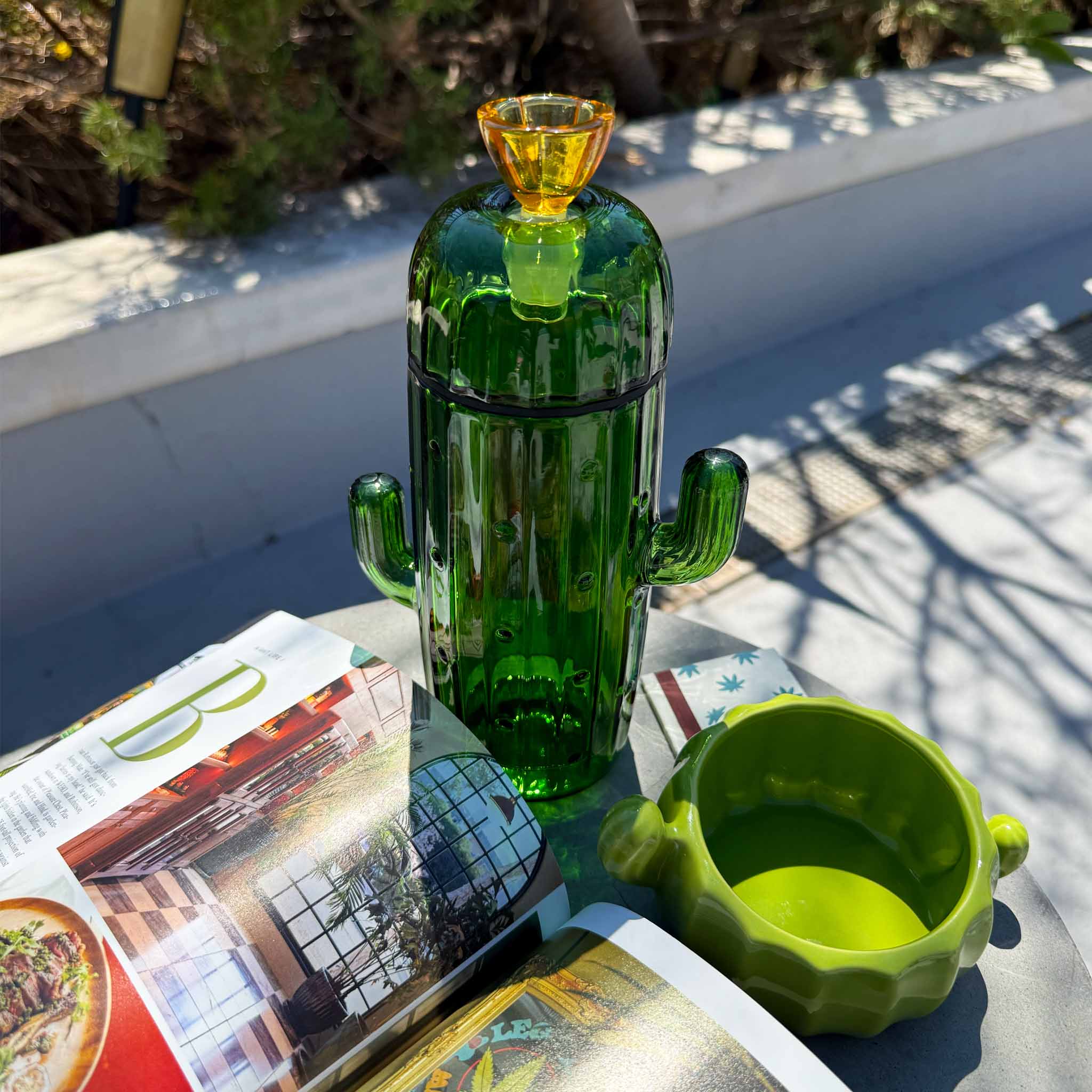 cactus gravity bong with ash tray on table top
