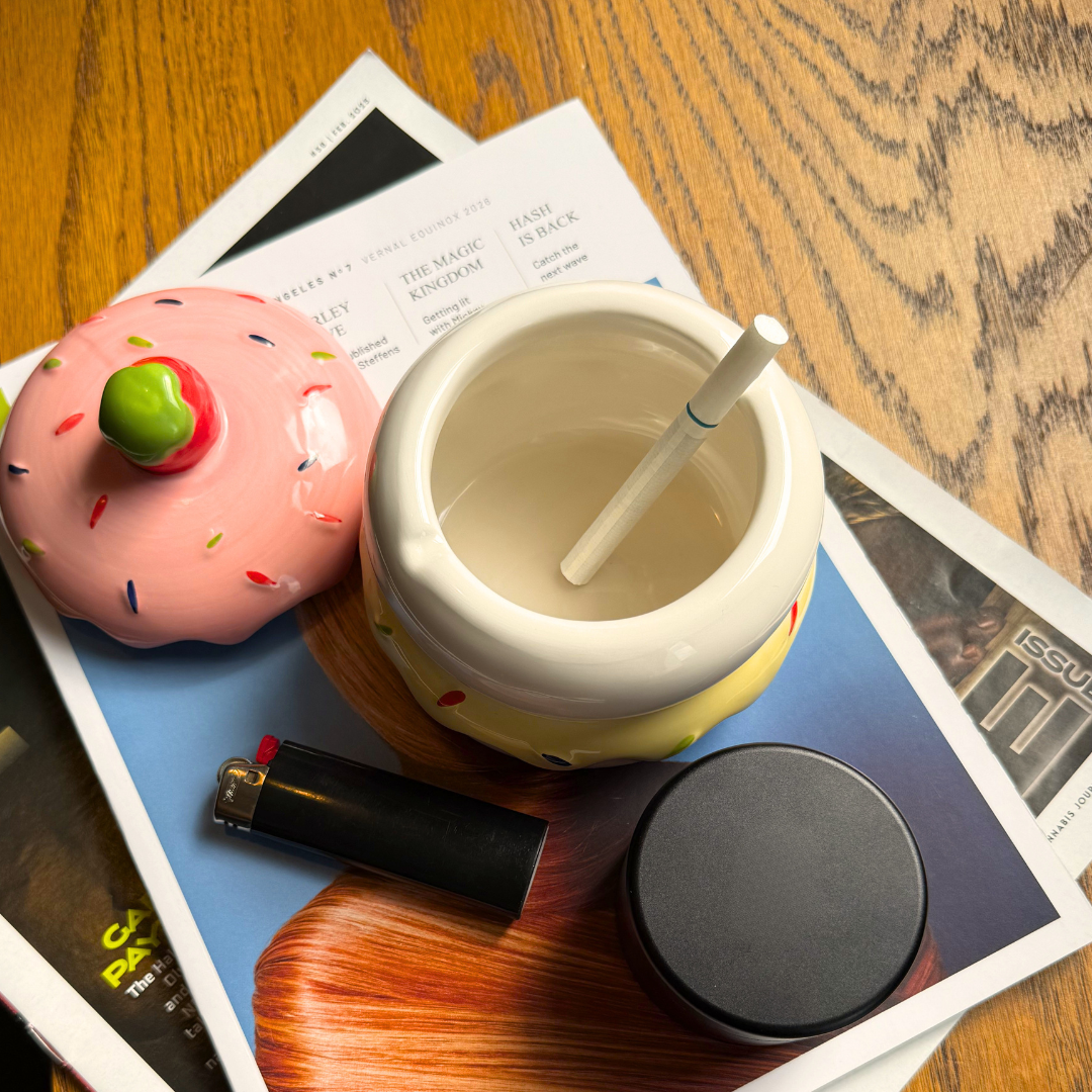 cake ash tray on table with cigarette