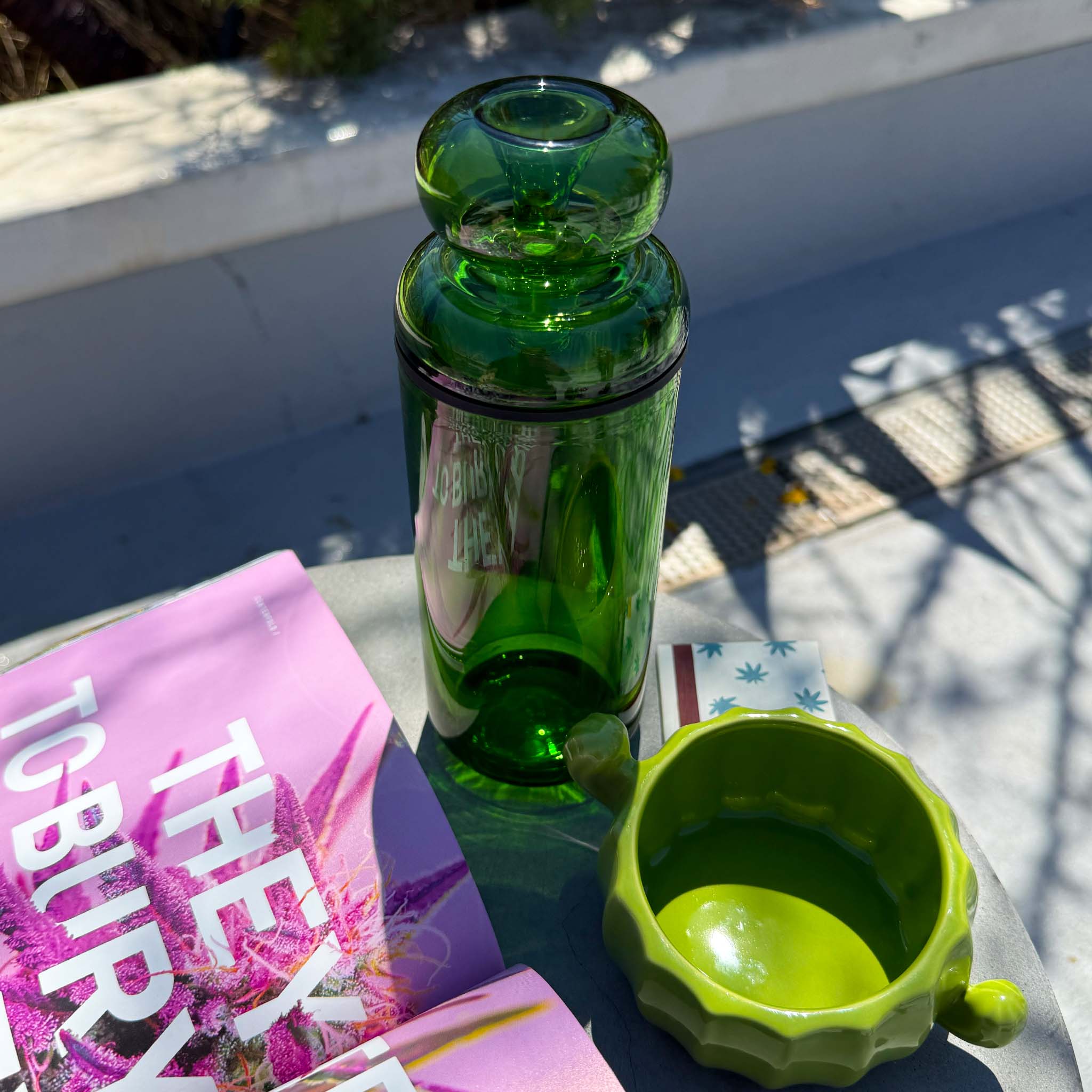 green gravity bong with cactus ash tray on table top