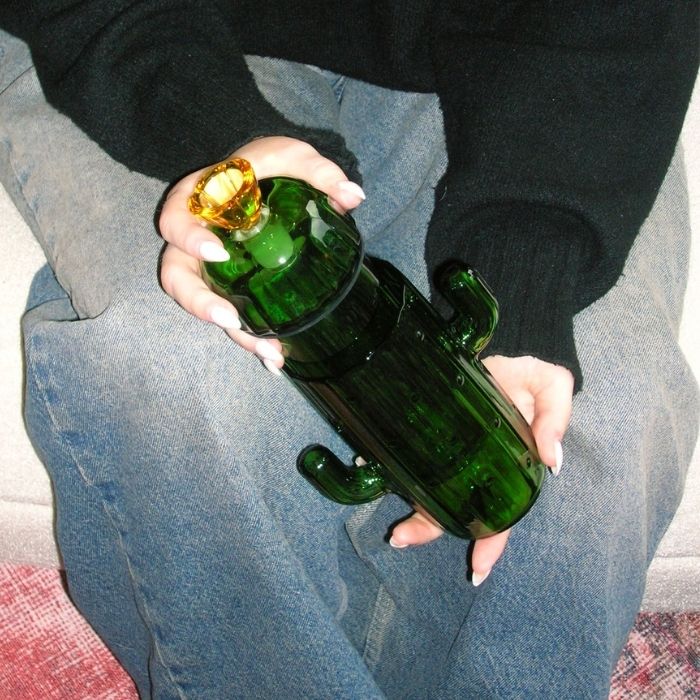 model holding cactus gravity bong 