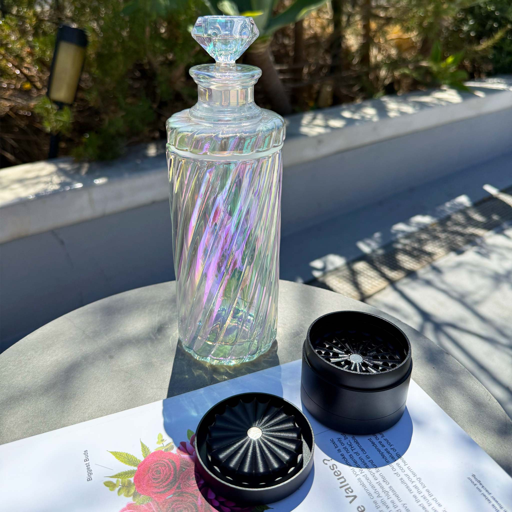 iridescent glass gravity bong with toothless grinder on tabletop