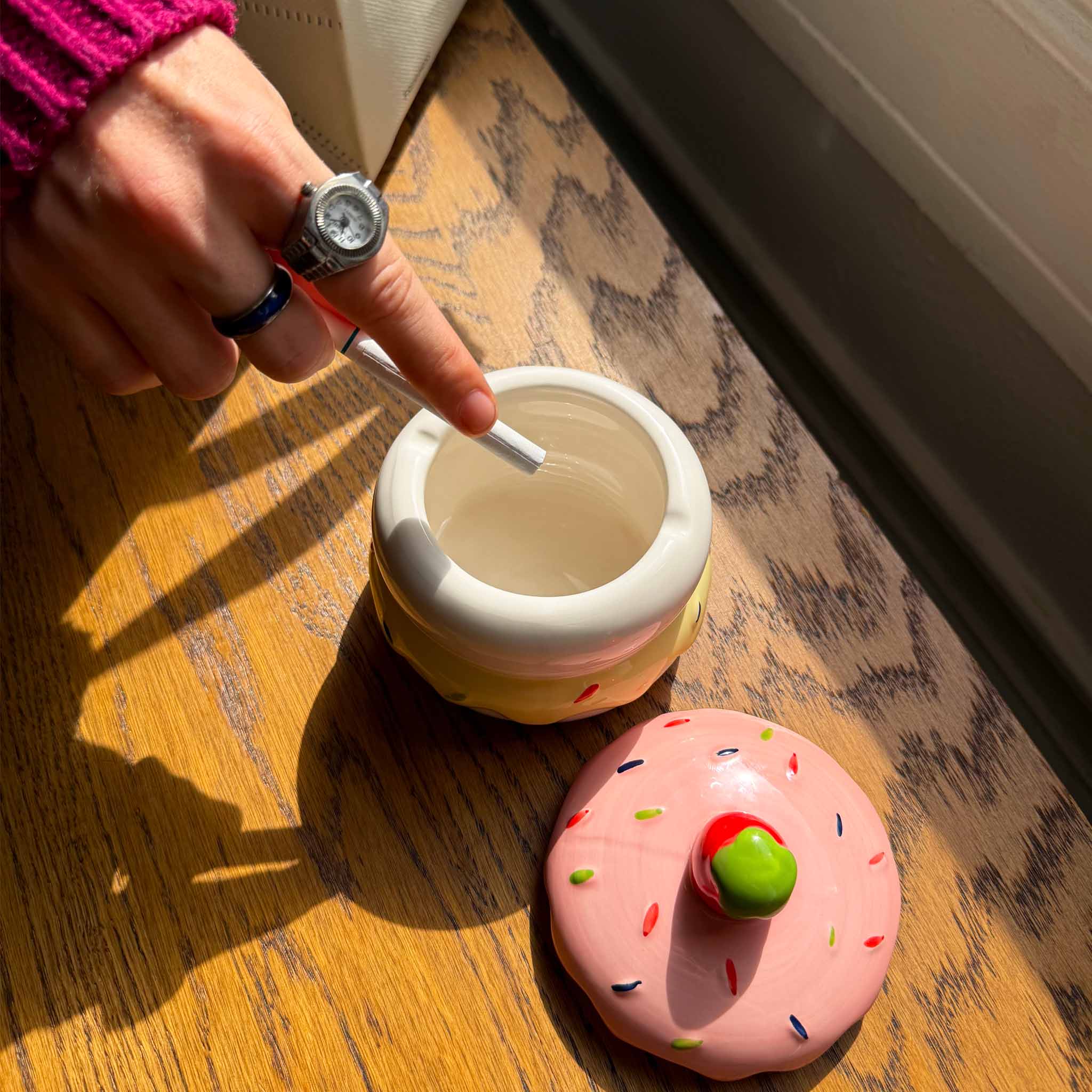 model ashing cigarette in cake ash tray
