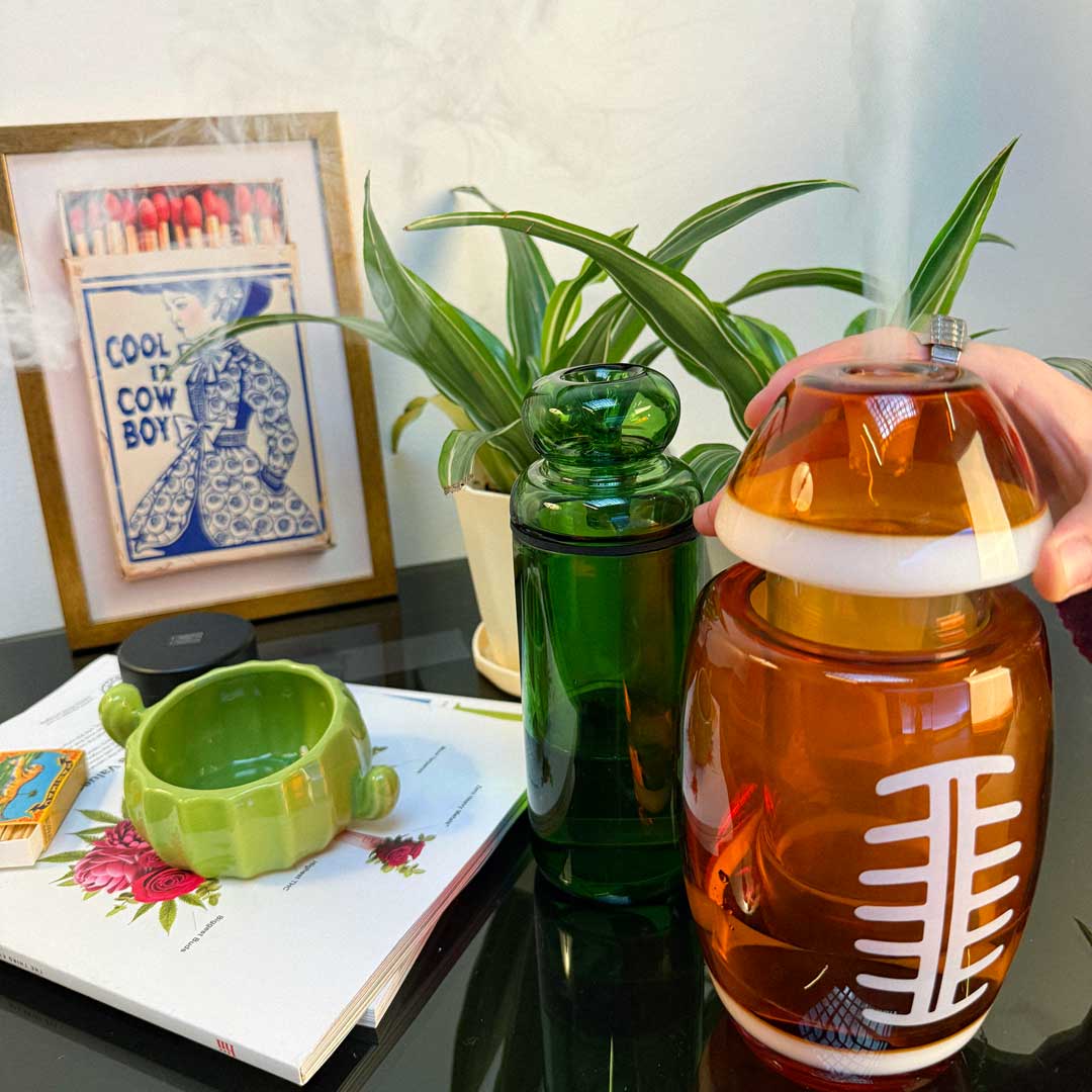 american football gravity bong and classic green glass gravity bong in use 