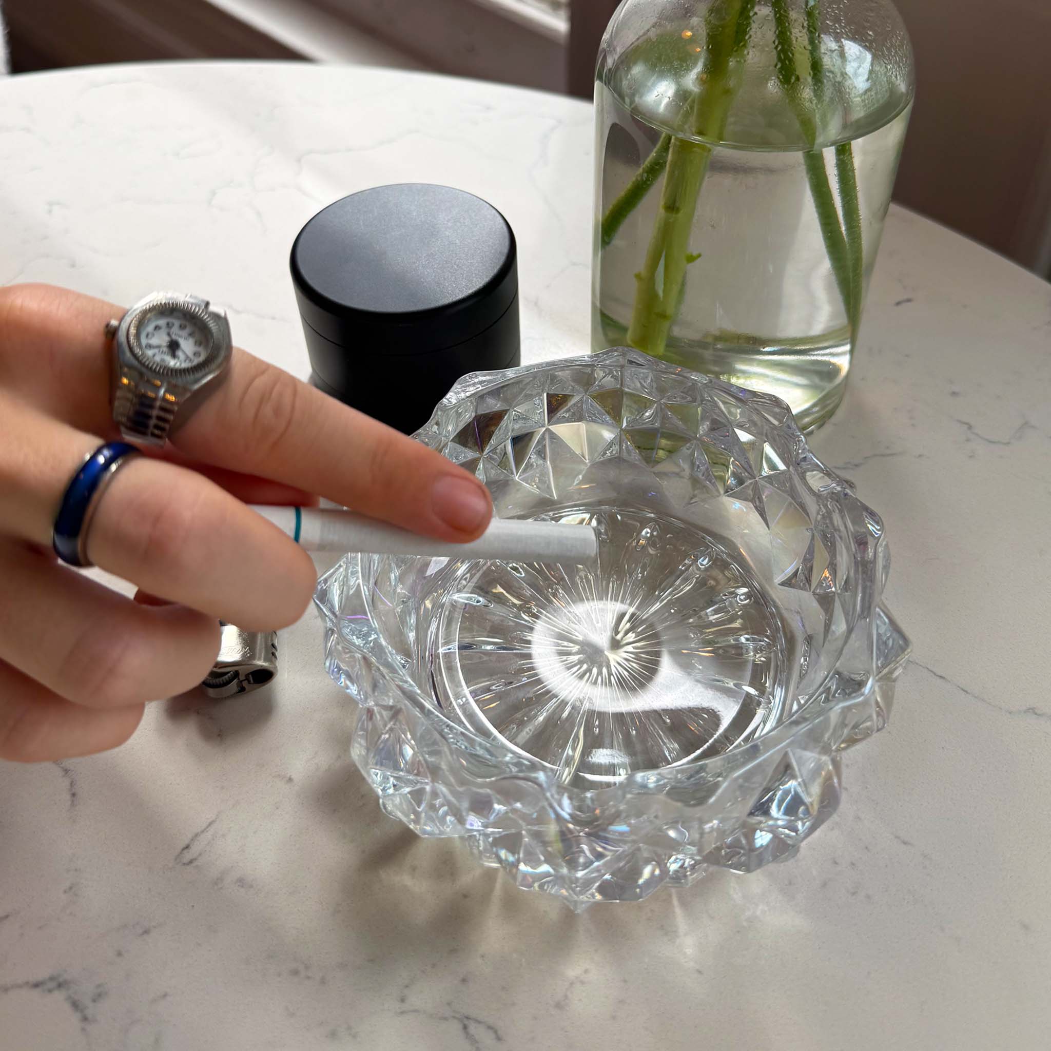 model ashing cigarette in iridescent ash tray