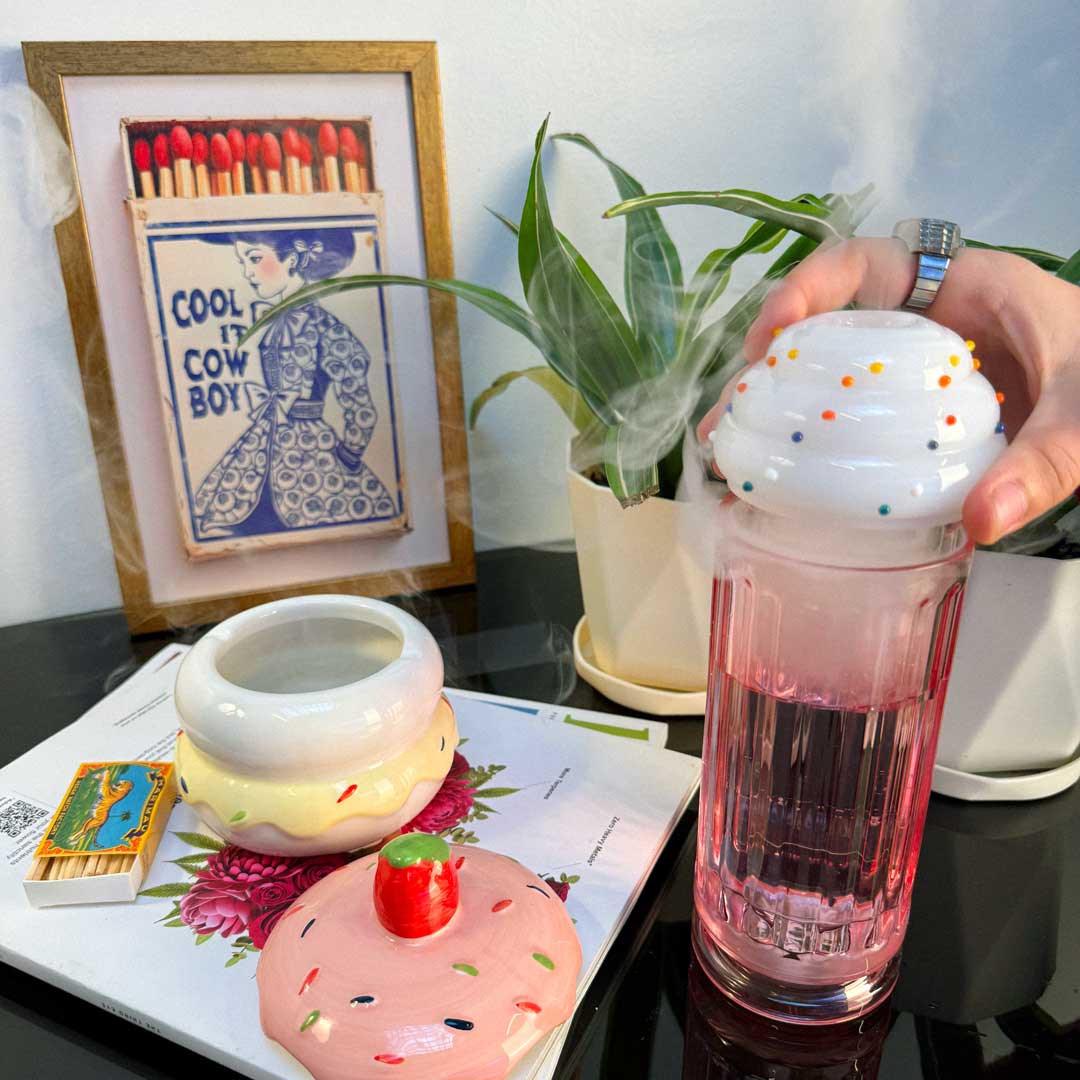 milkshake gravity bong in use on table with pancake ash tray 