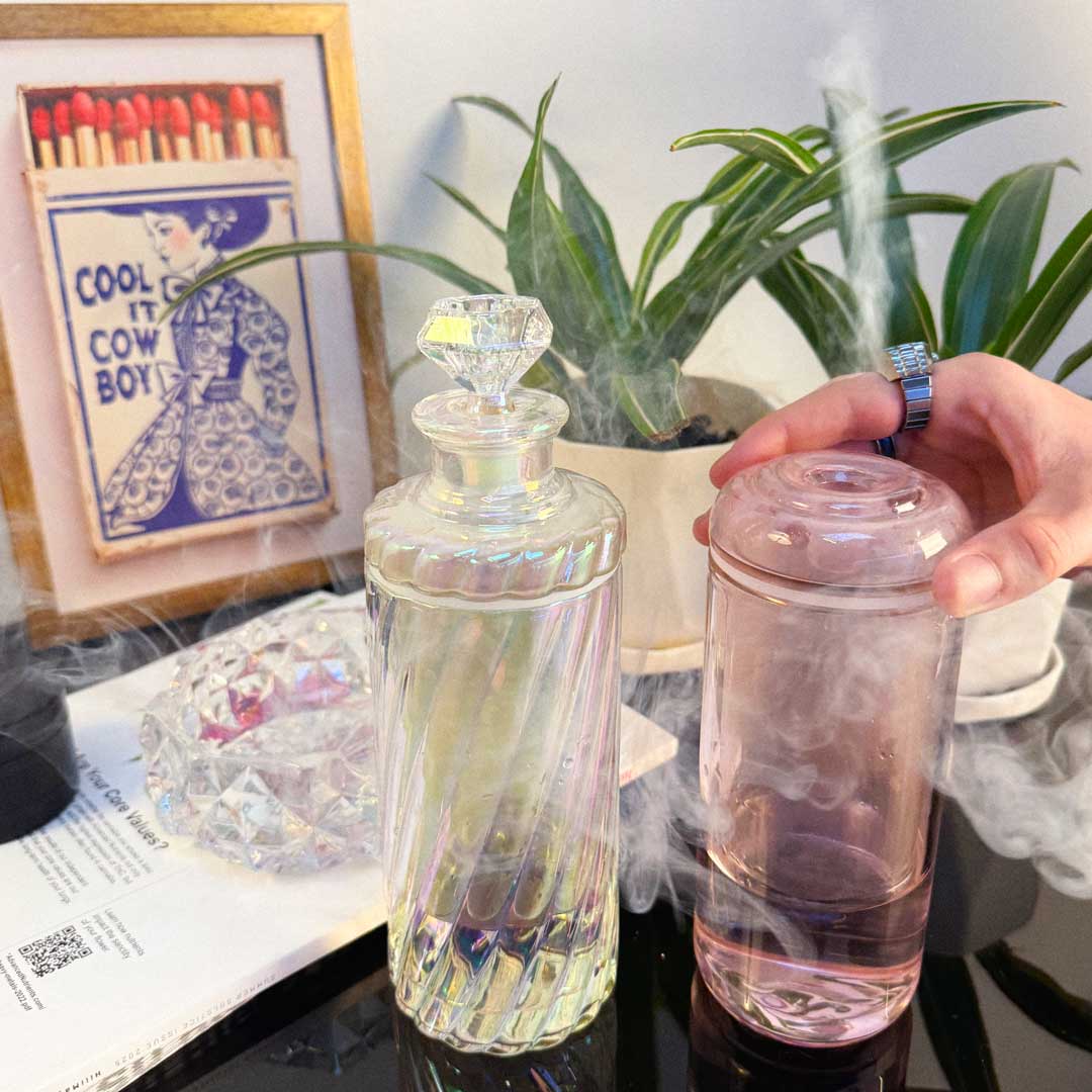 classic pink glass gravity bong and iridescent decanter gravity bong in use 